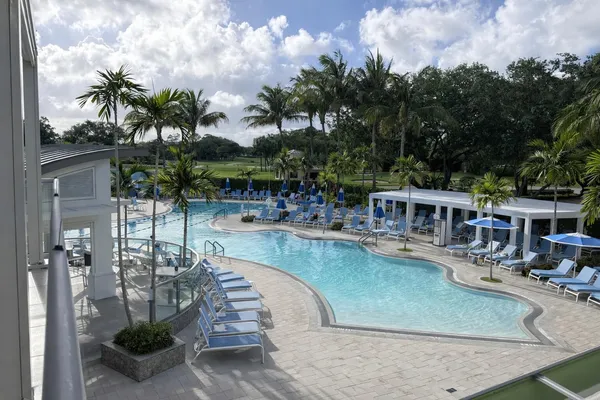 a view of a house with pool and sitting area