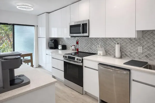 a kitchen with a sink stove and microwave