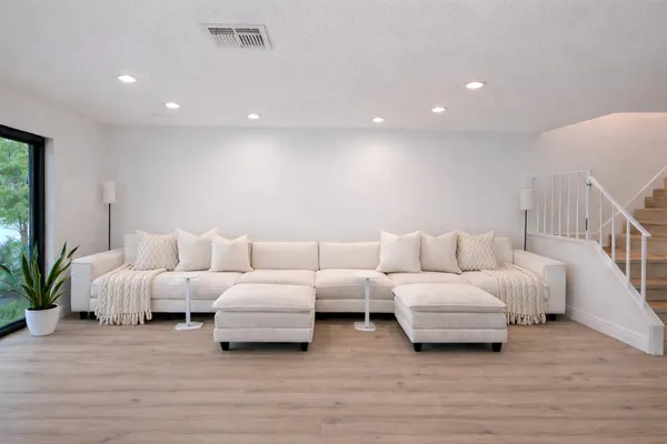 a living room with furniture and a potted plant
