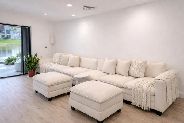 a living room with furniture and a large window
