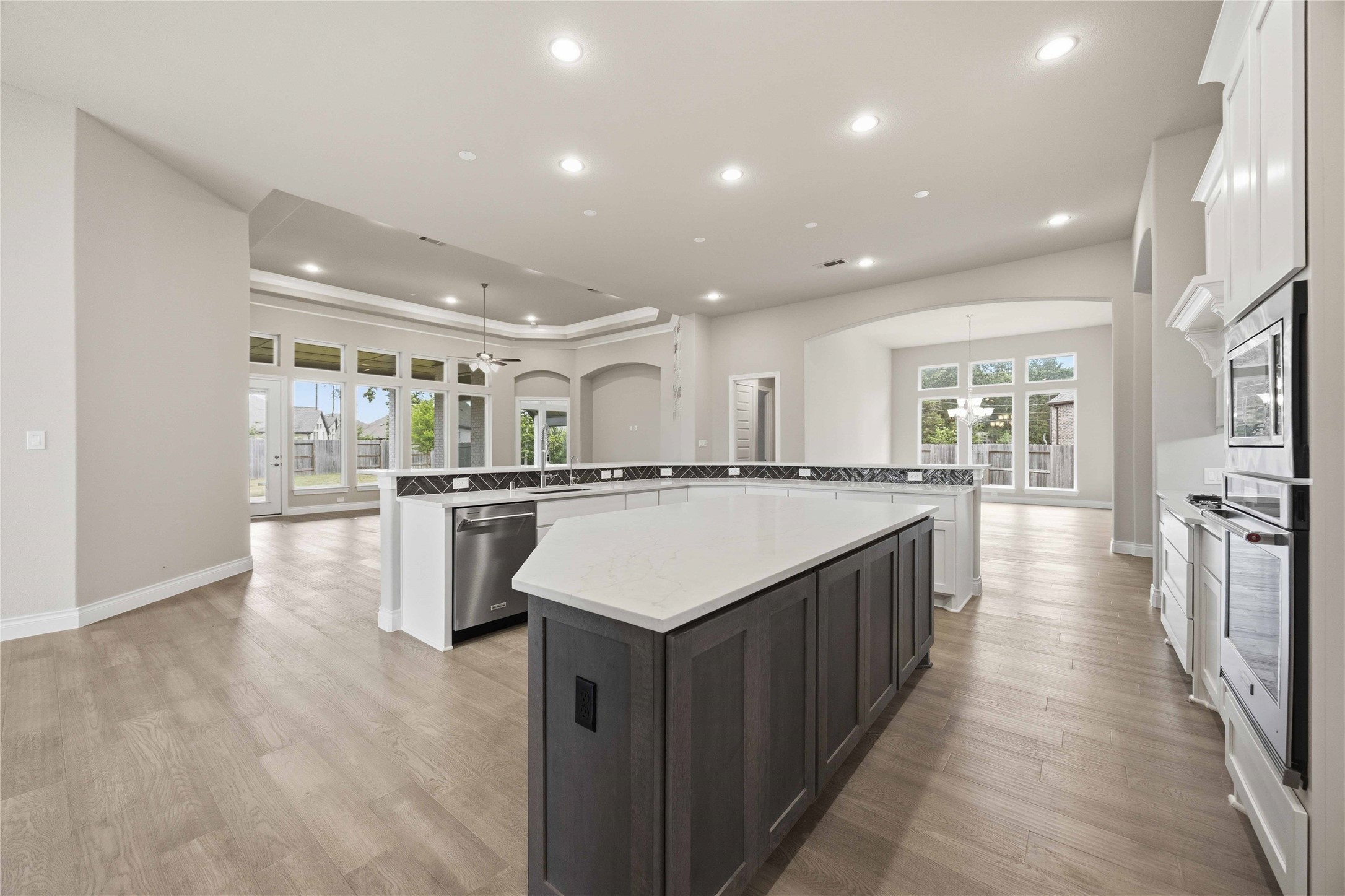 17564 Watercolor Way Conroe, TX 77302 - Photo 16 of 42 Chef's kitchen with quartz counter tops, stylish backsplash, expansive island, stainless steel appliances and walk in pantry
