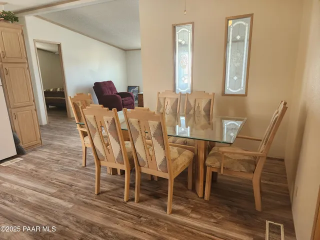 a view of a dining room with furniture and wooden floor