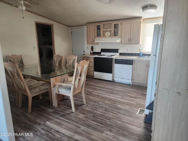 a view of kitchen with cabinets and wooden floor