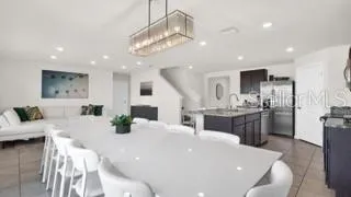 a large white kitchen with a large counter top appliances and cabinets