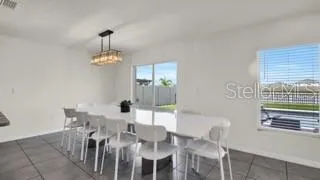 a view of a dining room with furniture and chandelier
