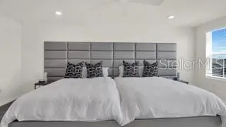 a spacious bedroom with a bed and window