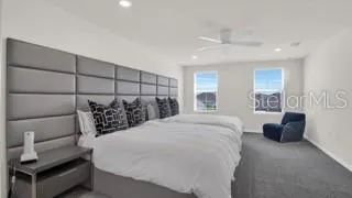 a spacious bedroom with a bed and a couch