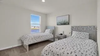 a bedroom with two beds and a window