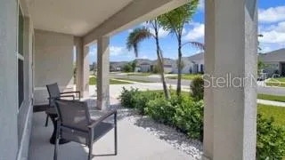 a view of an outdoor dining space with a table and chairs