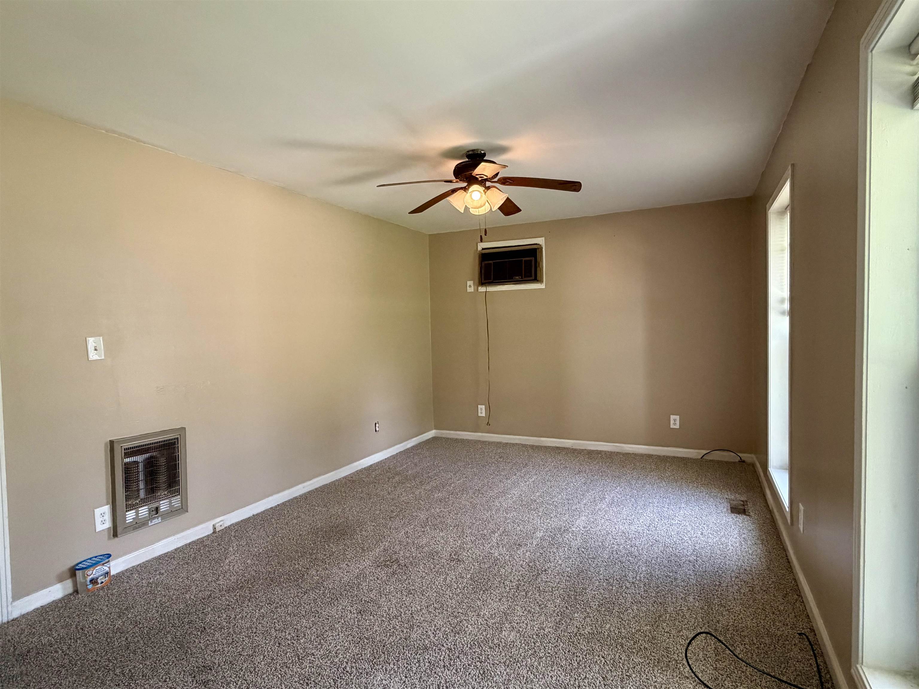 355 Purdy Road Selmer, TN 38375 - Photo 4 of 14 Carpeted interior space featuring light beige walls and white trim