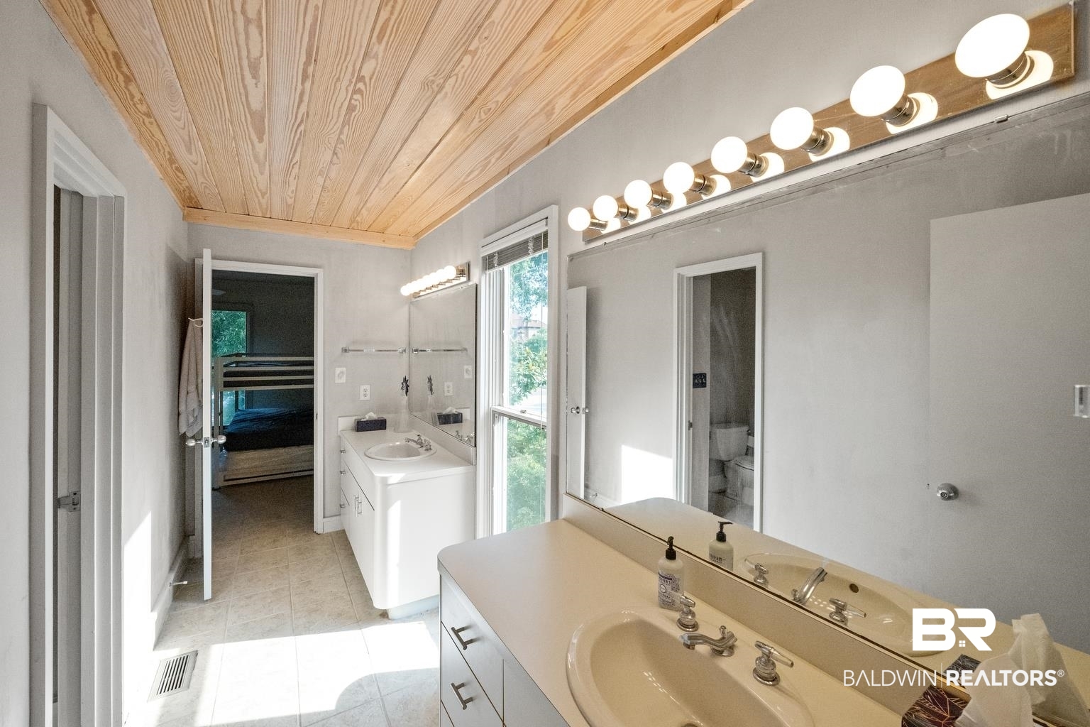 29255 Ono Boulevard Orange Beach, AL 36561 - Photo 30 of 43 Full bathroom featuring wooden ceiling, tile patterned flooring, vanity, and ensuite bathroom