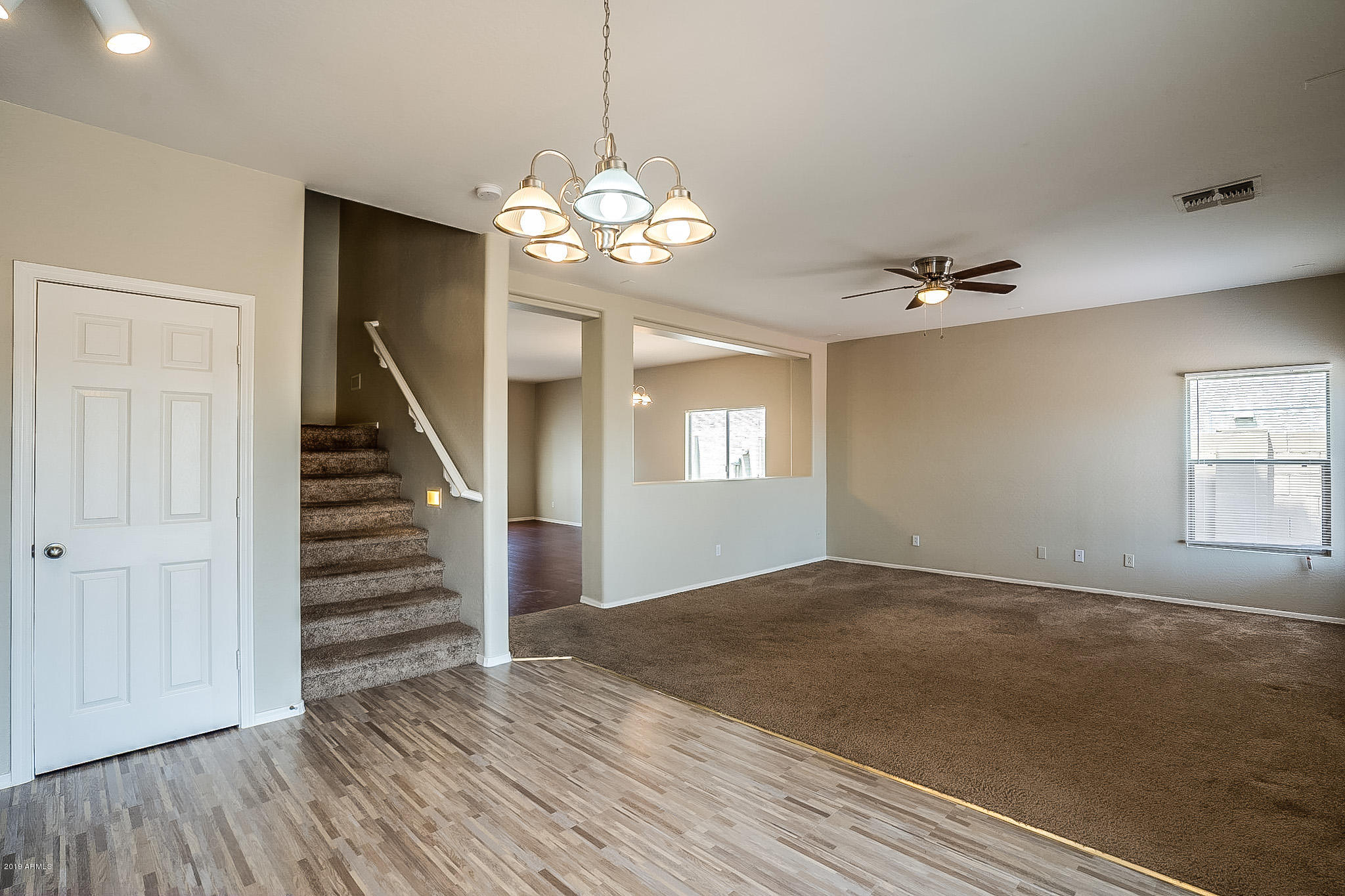 5118 West Apollo Road Laveen, AZ 85339 - Photo 21 of 57 a view of an empty room with wooden floor and stairs