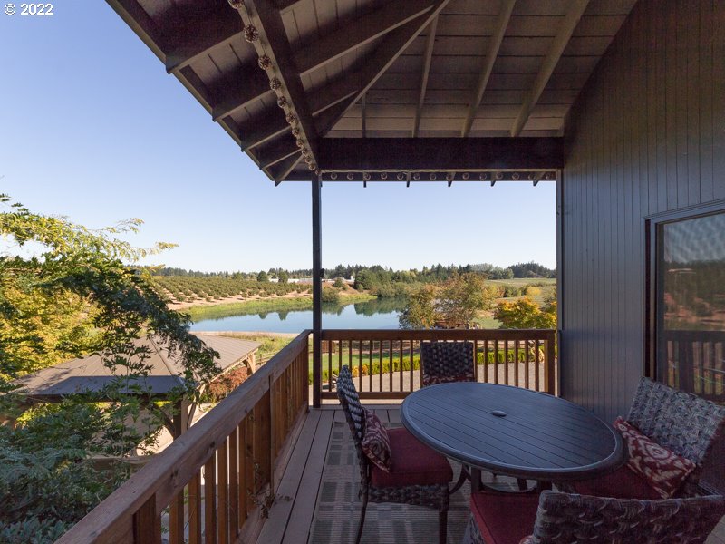 32000 Southwest Firdale Road Cornelius, OR 97123 - Photo 6 of 29 a view of a balcony with table and chairs and wooden floor