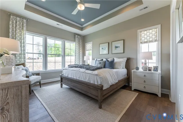 a bedroom with a large bed and a chandelier