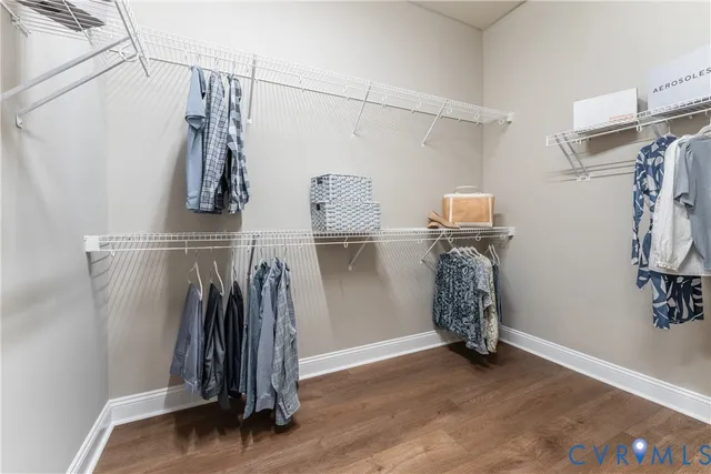 a view of walk in closet with clothes