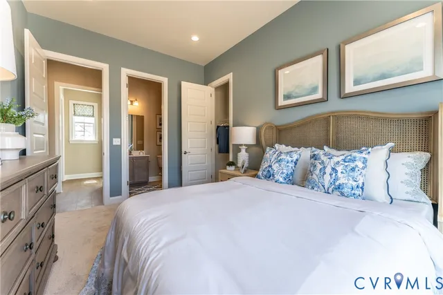 a bedroom with a large bed and a chandelier