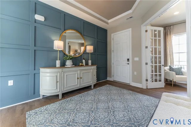 a living room with furniture and a mirror