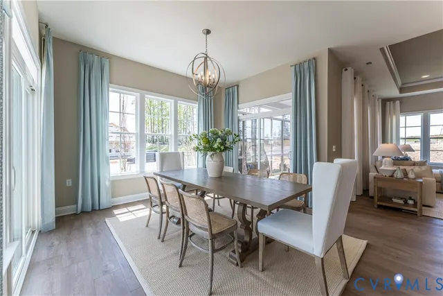 a view of a dining room with furniture wooden floor and chandelier