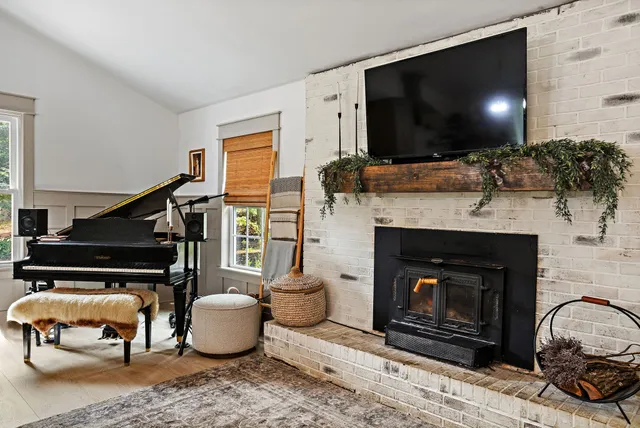 a living room with furniture a flat screen tv and a fireplace