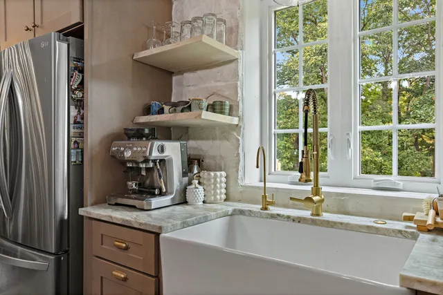 a kitchen with stainless steel appliances granite countertop a stove and cabinets
