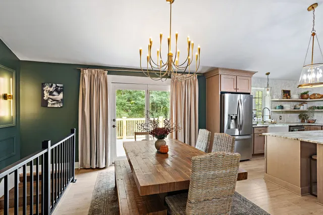 a dining room with furniture a chandelier and wooden floor