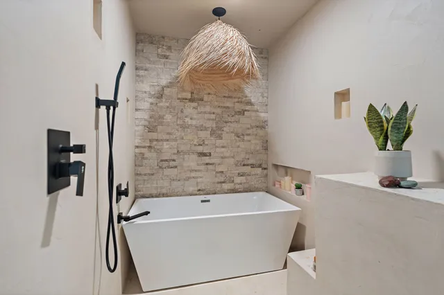 a view of a hallway with workspace and a window