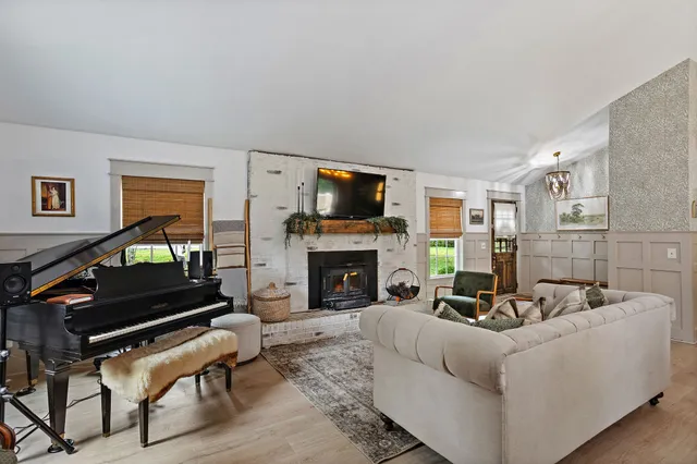 a living room with furniture a fireplace a flat screen tv and a fireplace