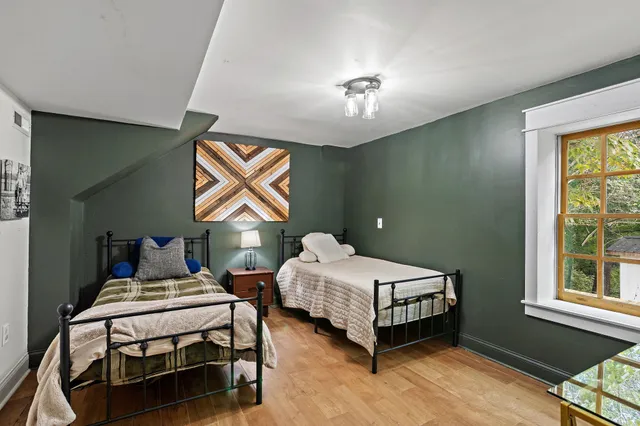 a view of a house with wooden deck and furniture