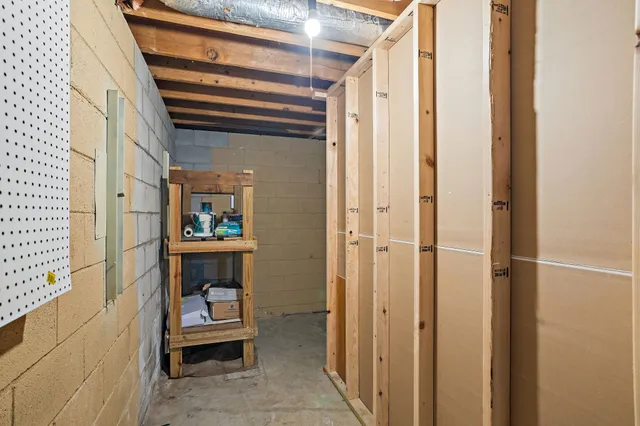 an aerial view of residential house with outdoor space and trees all around
