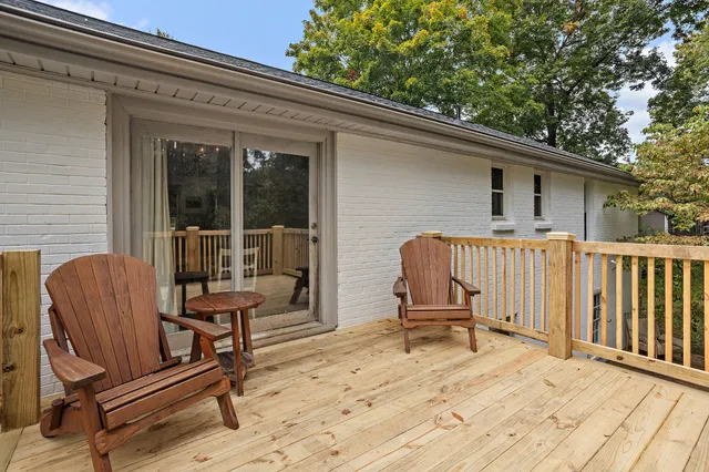 an aerial view of a house with a yard and outdoor seating