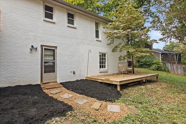 a view of a city with lush green forest