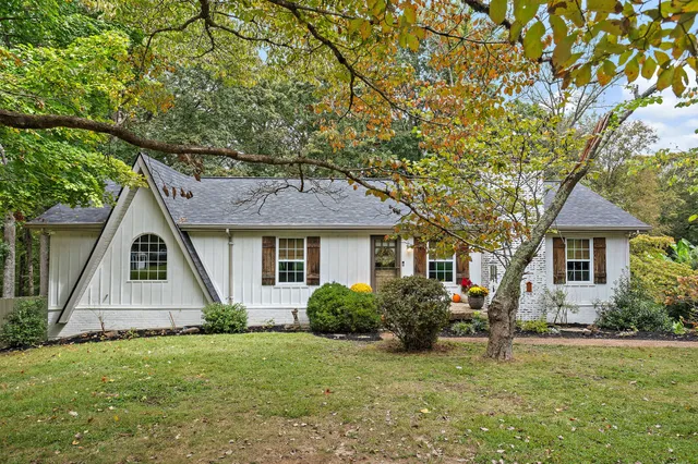 a front view of house with yard and green space