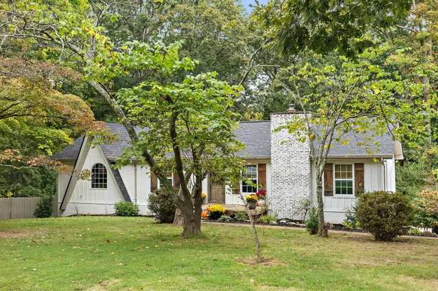a living room with furniture wooden floor and a fireplace