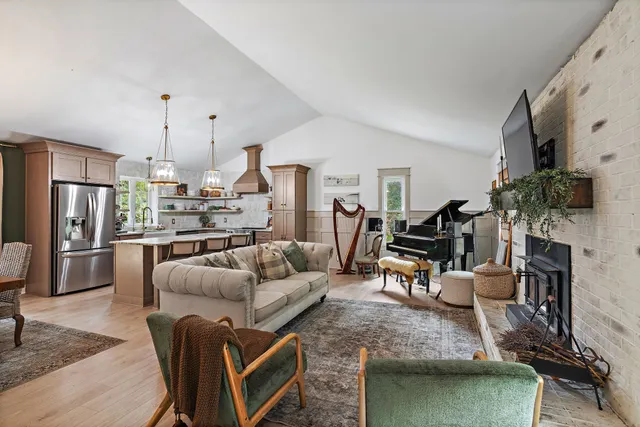 a living room with furniture a flat screen tv and a fireplace