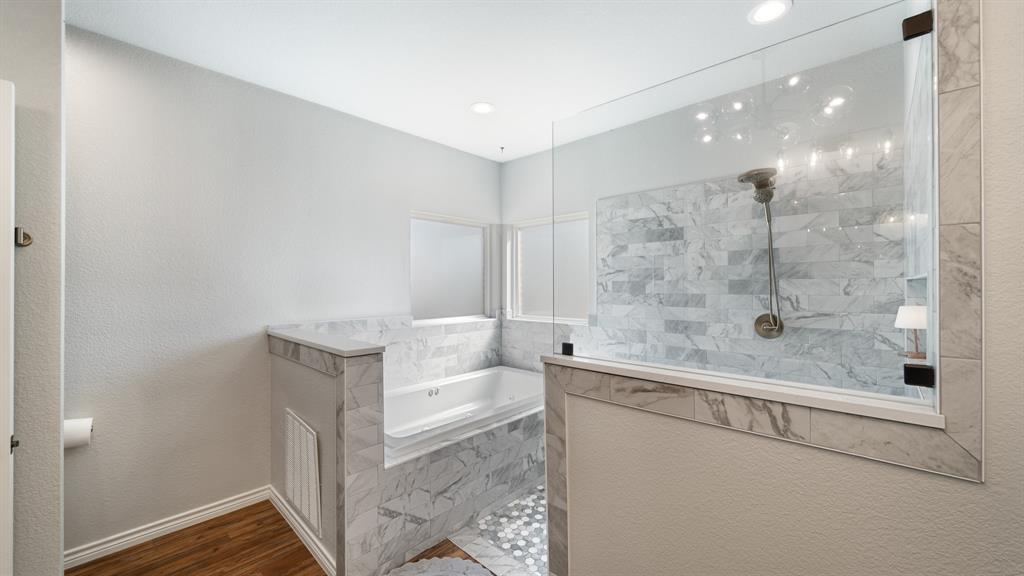 101 Lighthouse Lane Mabank, TX 75143 - Photo 20 of 40 Full bathroom featuring a walk in shower, a bath, a textured wall, and dark wood-type flooring