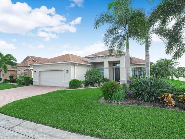 a front view of a house with a garden and yard