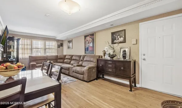 a living room with furniture a wooden floor and a window