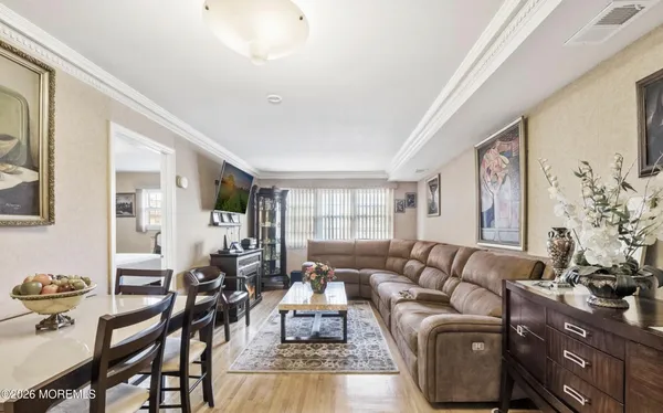 a living room with furniture wooden floor and a large window