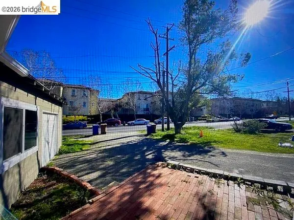 a view of a backyard with wooden fence