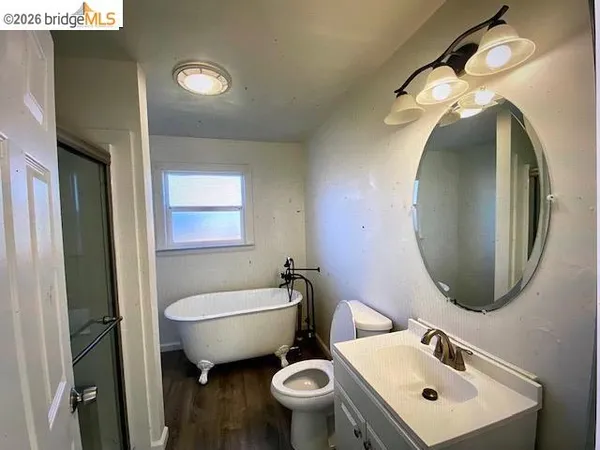 a bathroom with a toilet sink and mirror