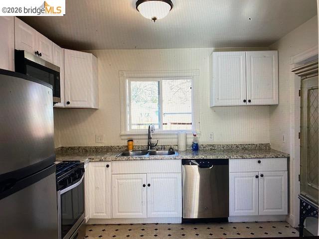 230 Cleaveland Road Pleasant Hill, CA 94523 - Photo 8 of 8 a kitchen with granite countertop white cabinets and stainless steel appliances