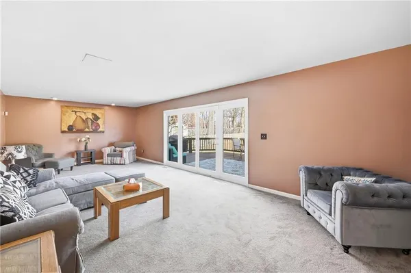 a living room with furniture and a floor to ceiling window