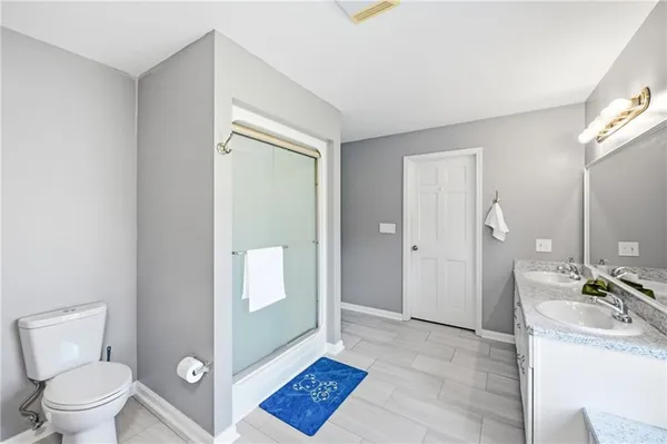 a bathroom with a sink a toilet and a mirror