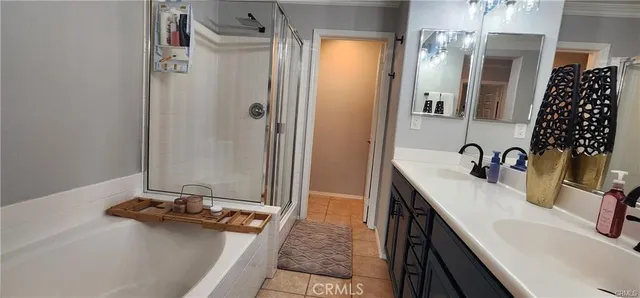 a bathroom with a double vanity sink a mirror and a shower