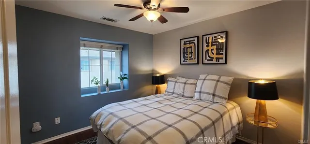 a bedroom with a large bed and a window