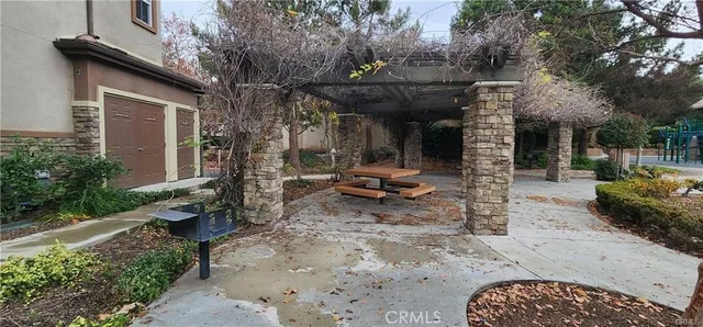 a view of a chair and table in backyard of the house