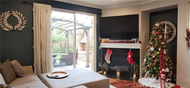 a living room with furniture a flat screen tv and a fireplace