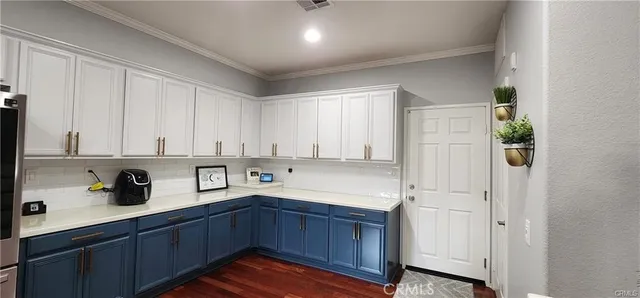 a kitchen with cabinets a sink and appliances