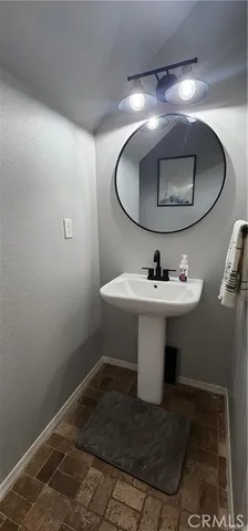 a bathroom with a sink toilet and a mirror