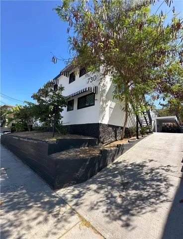 a view of a house with snow on the road